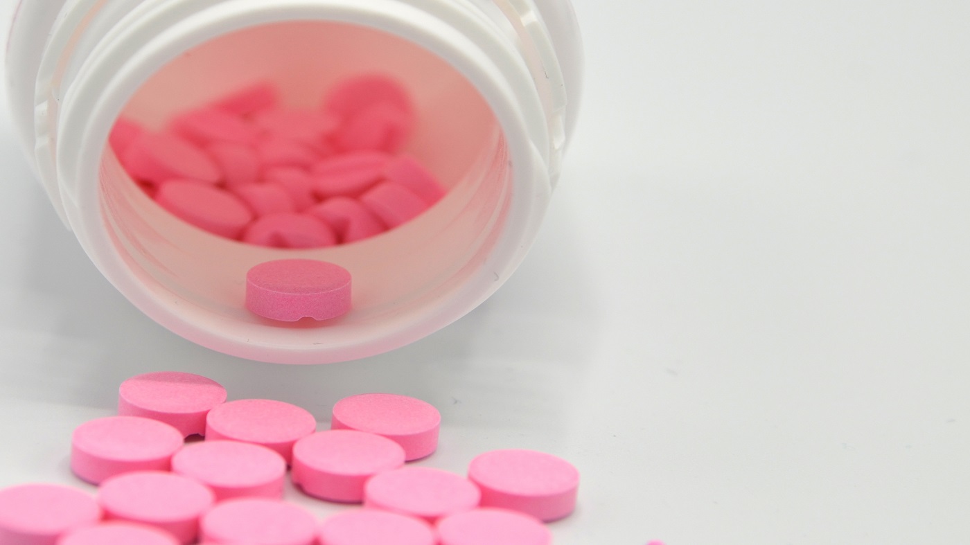 Warfarin Supplement Interactions -- bottle of pink warfarin tablets